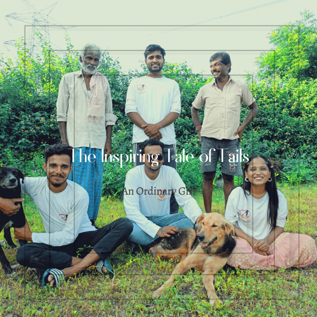 Animal welfare workers sit on the grass with two rescued dogs.